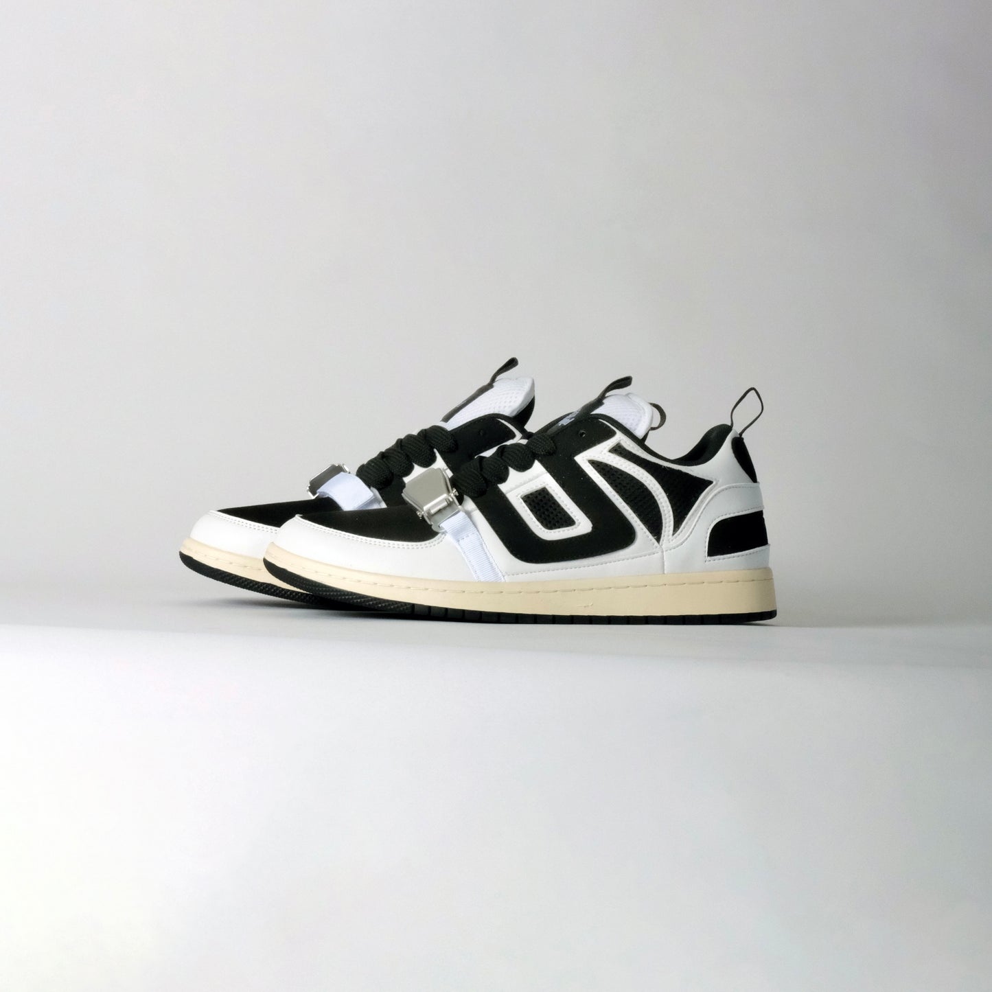 UNTD Amity Low Panda shoe with black toe box, white side panels, and thick black laces