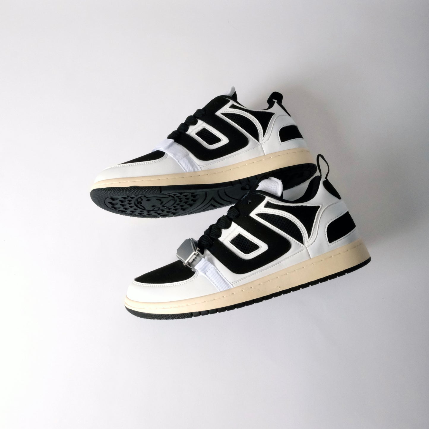UNTD Amity Low Panda shoe with black toe box, white side panels, and thick black laces