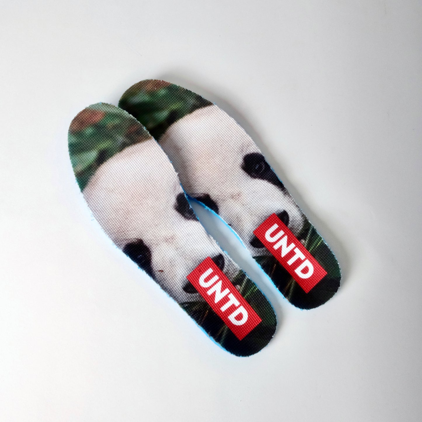 UNTD Amity Low Panda shoe with black toe box, white side panels, and thick black laces