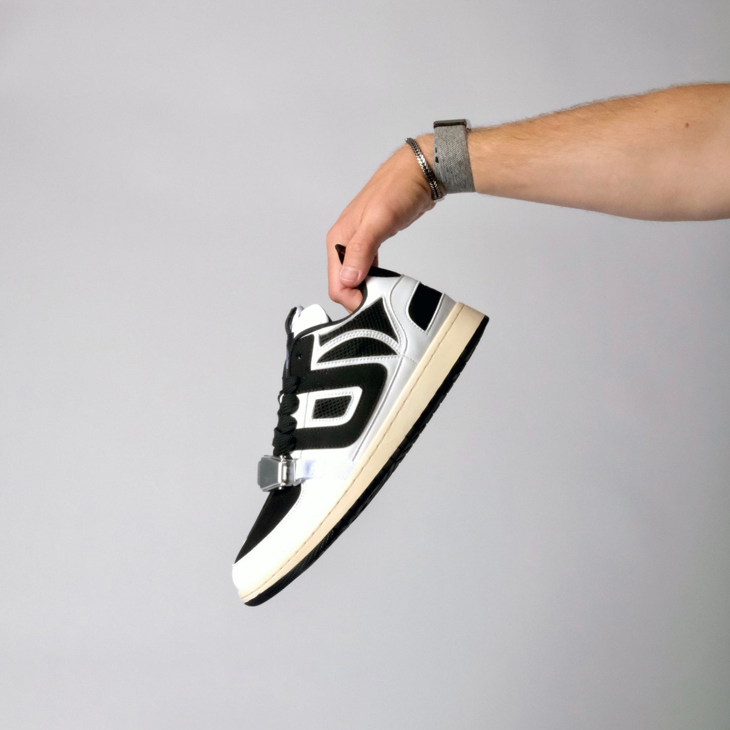 UNTD Amity Low Panda shoe with black toe box, white side panels, and thick black laces