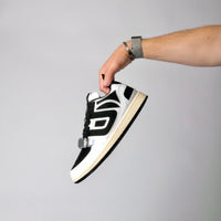UNTD Amity Low Panda shoe with black toe box, white side panels, and thick black laces